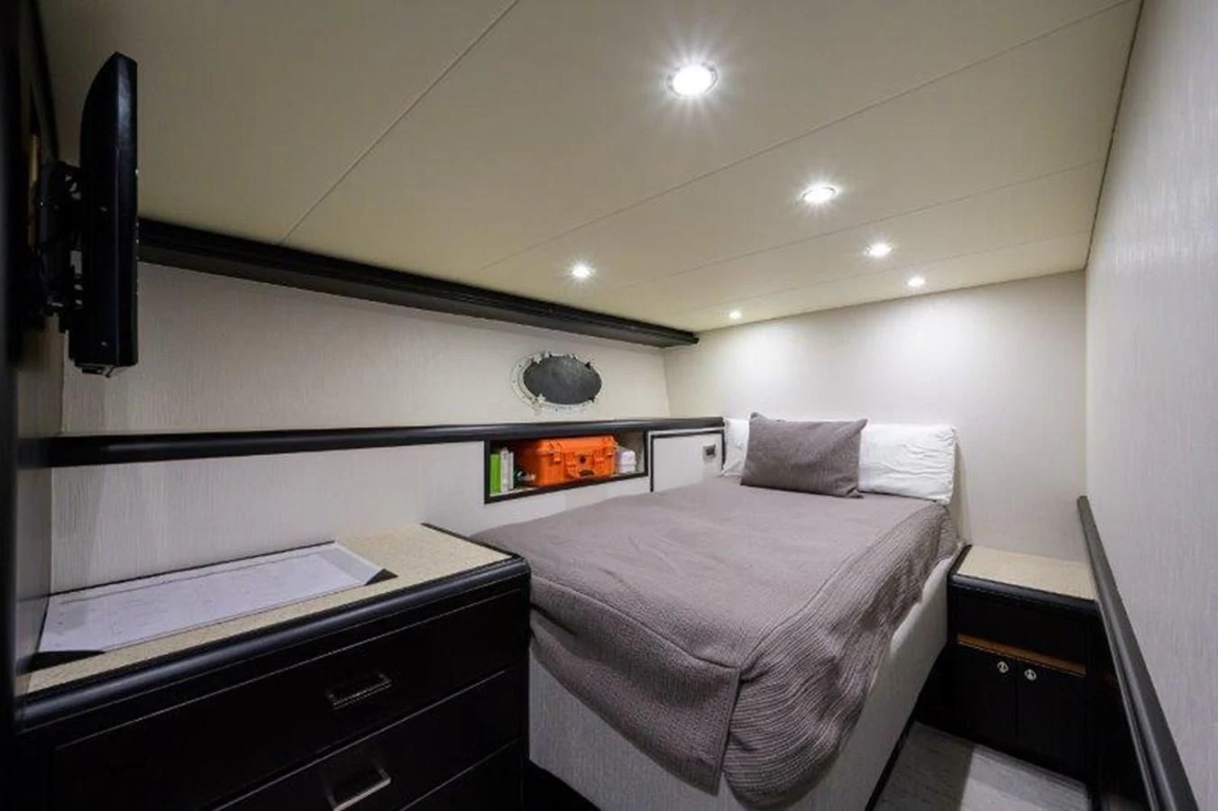 a bedroom with a bed and a television aboard ODYSSEY Yacht for Sale