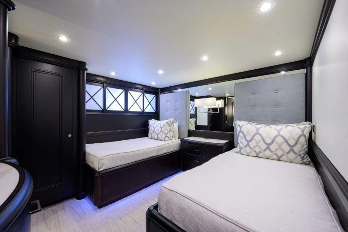 a room with a bed and a mirror aboard ODYSSEY Yacht for Sale