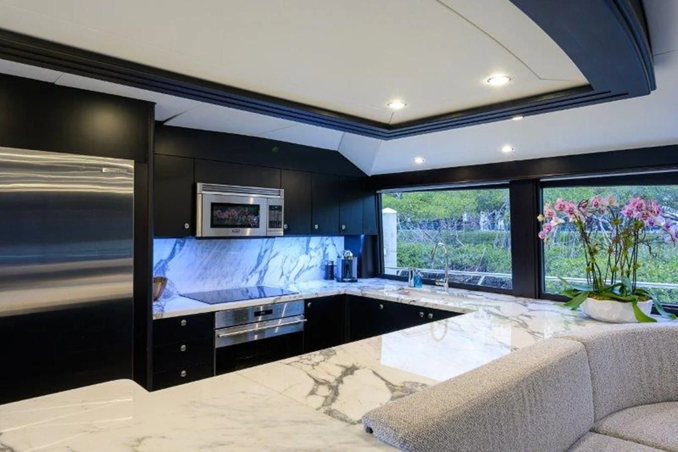 a modern kitchen with a large window aboard ODYSSEY Yacht for Sale