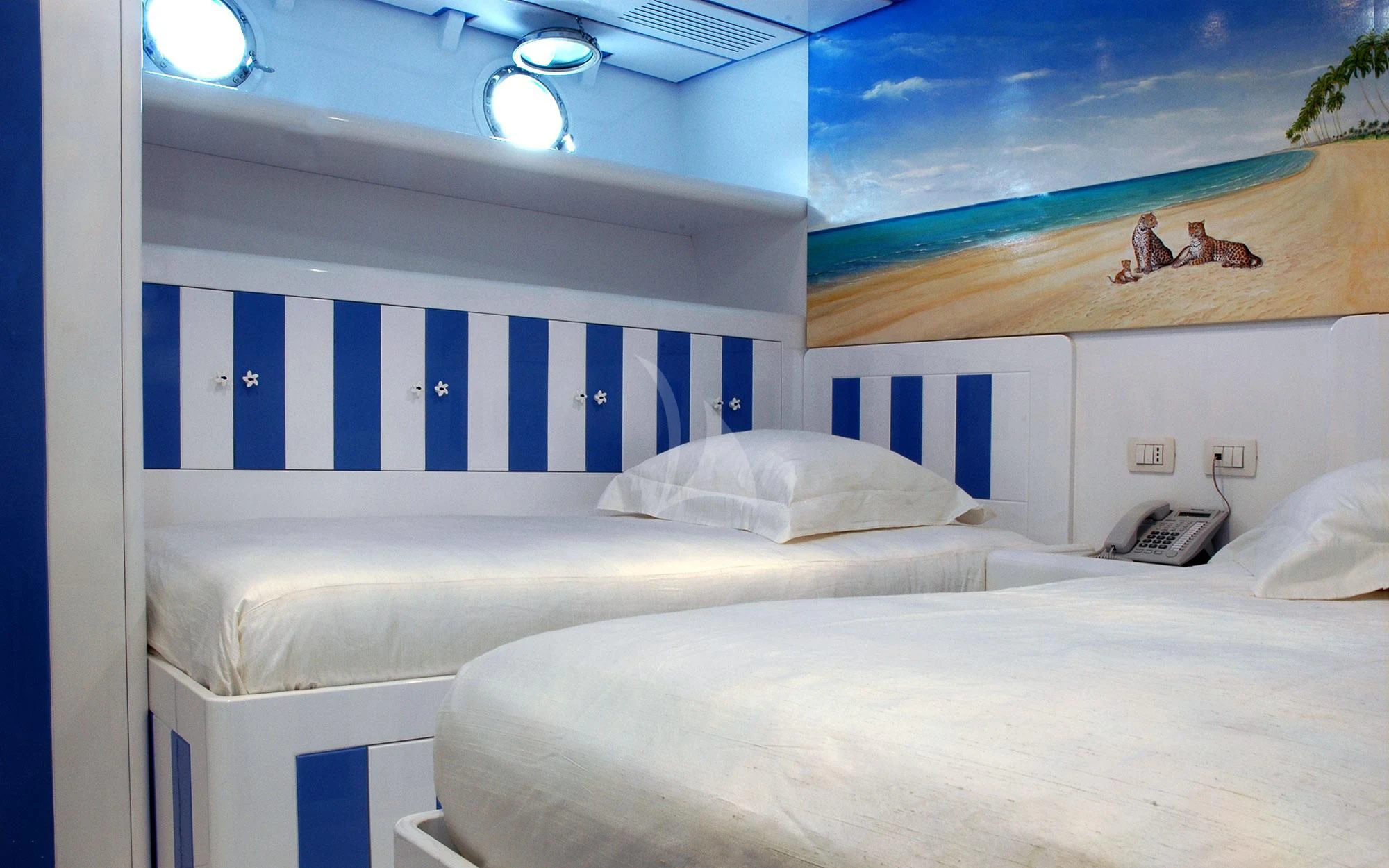 a room with blue and white walls aboard MATA MUA Yacht for Sale