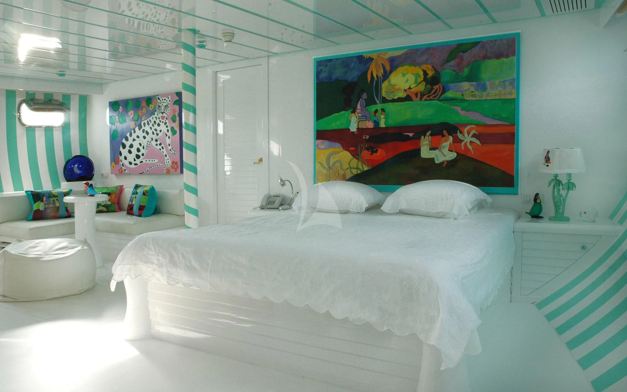 a room with a bed and a painting on the wall aboard MATA MUA Yacht for Sale