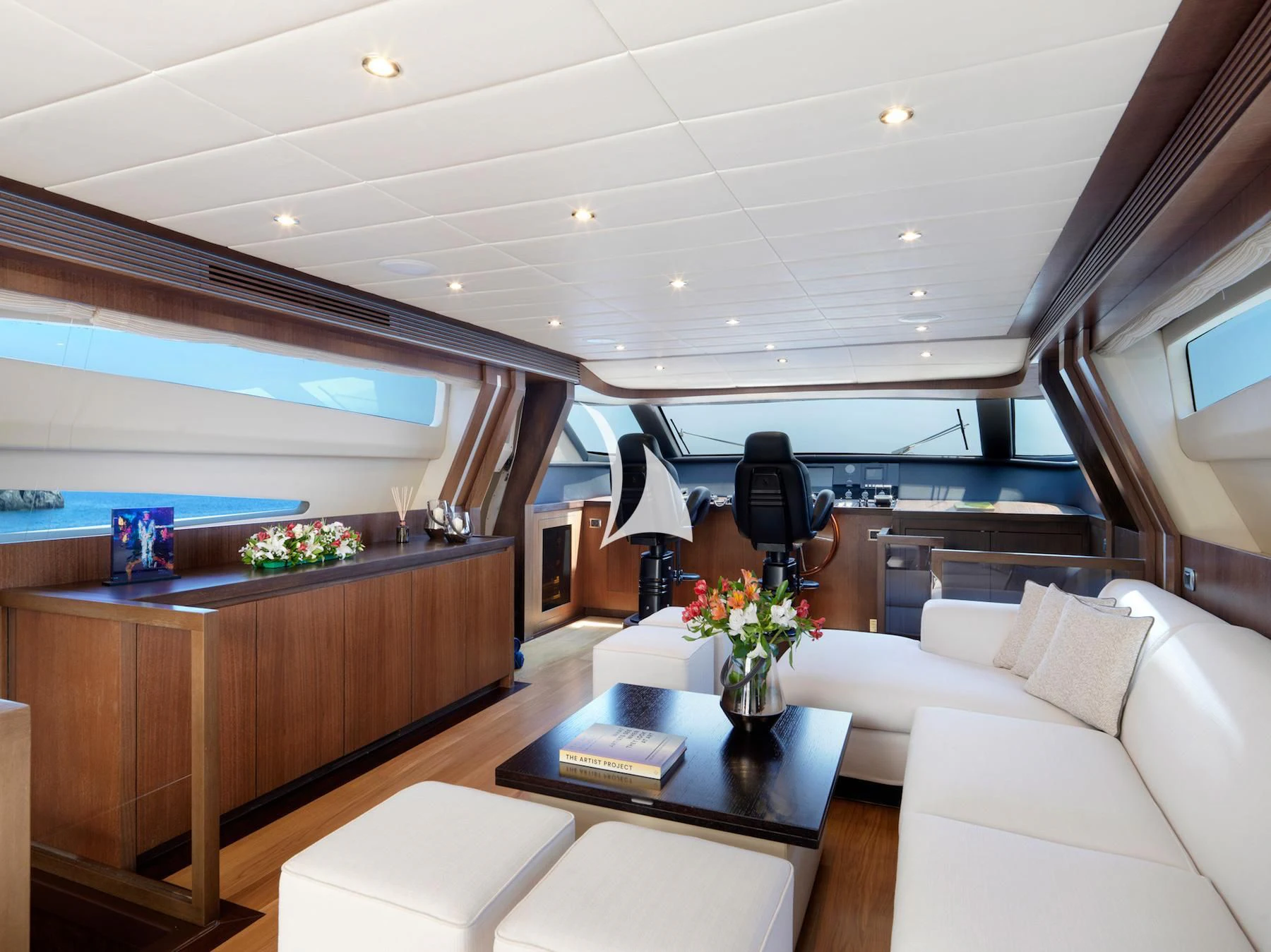 a room with a couch and a table with a chair aboard RUBY Yacht for Charter