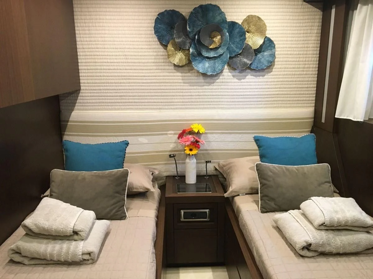 a room with a couch and a bed aboard RUBY Yacht for Charter