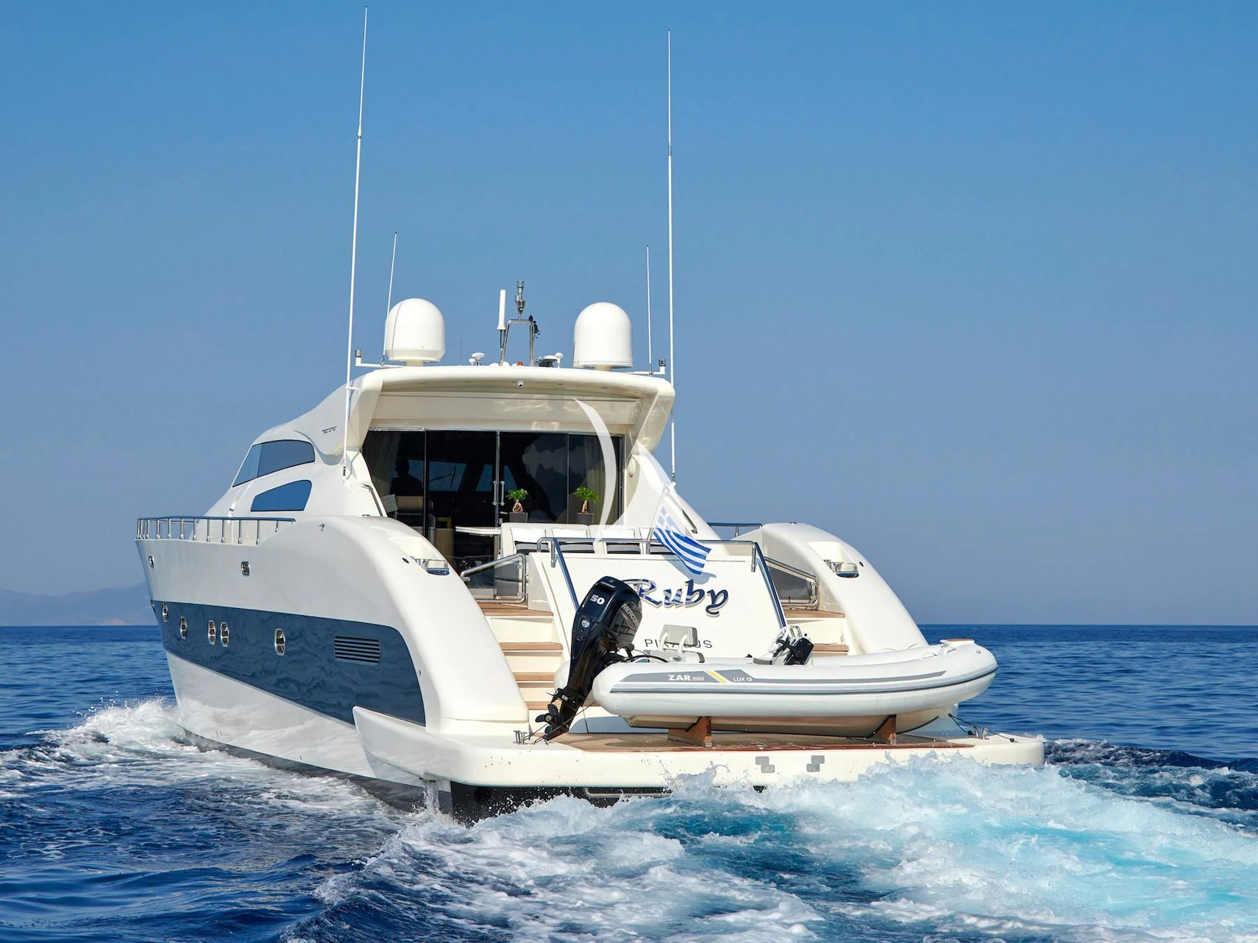 a white boat in the water aboard RUBY Yacht for Charter