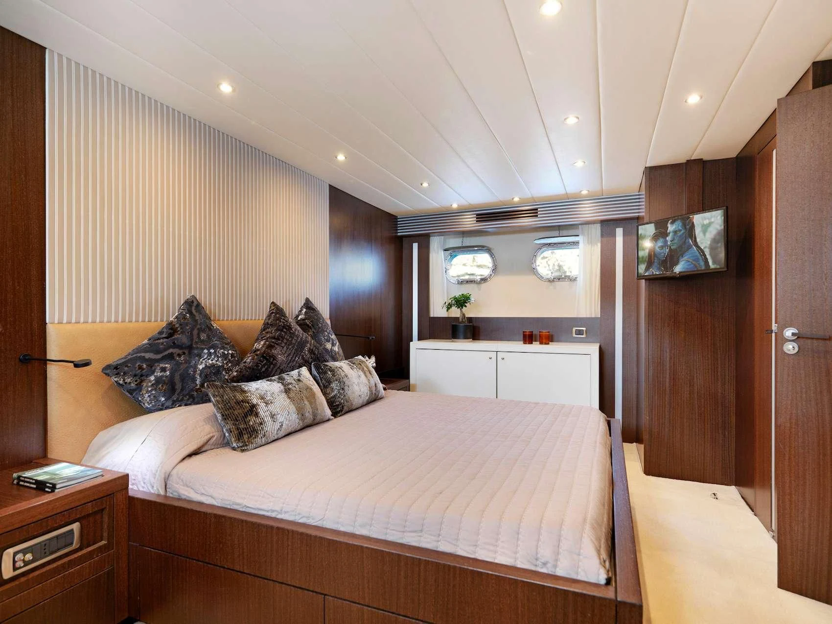 a bedroom with a bed and a desk aboard RUBY Yacht for Charter