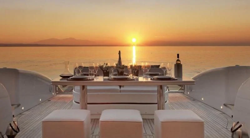 a large white boat with a table and chairs on it aboard RUBY Yacht for Charter