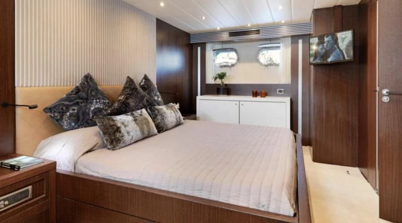 a bed with pillows aboard RUBY Yacht for Charter
