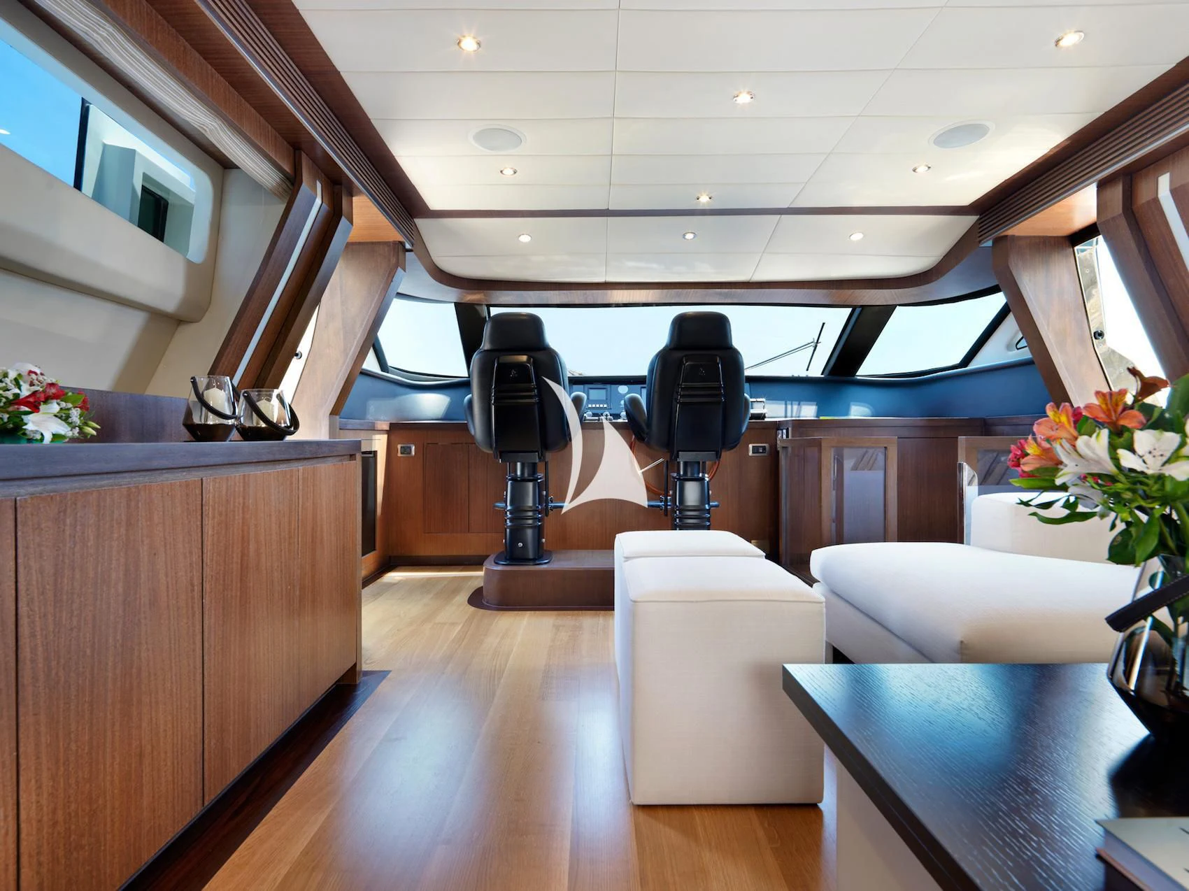 a room with a chair and a table and a couch aboard RUBY Yacht for Charter
