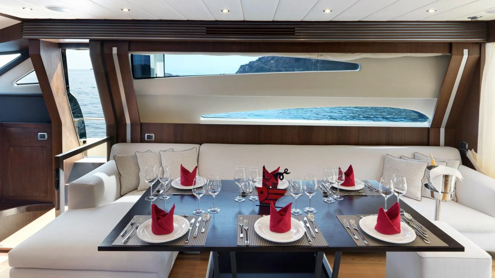 a table with plates and glasses aboard RUBY Yacht for Charter