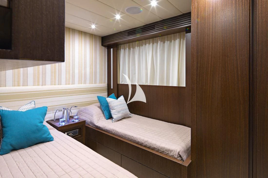 a couple of beds in a hotel room aboard RUBY Yacht for Charter