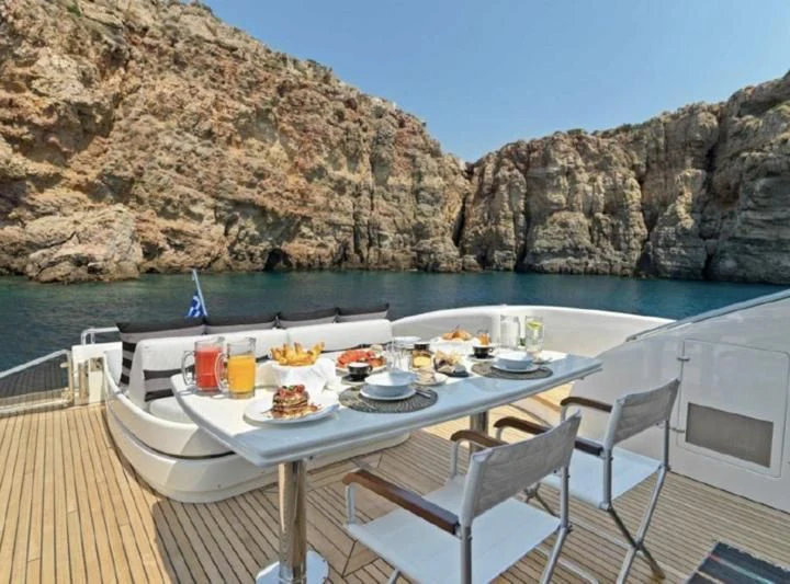 a table set for a meal on a boat on a body of water aboard RUBY Yacht for Charter