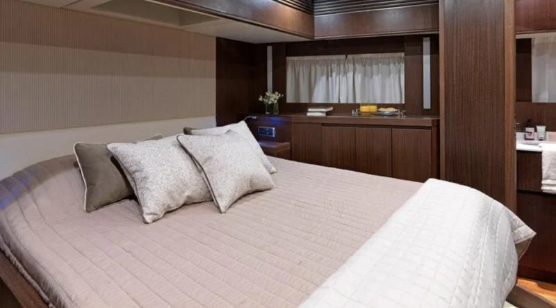a bed with pillows aboard RUBY Yacht for Charter