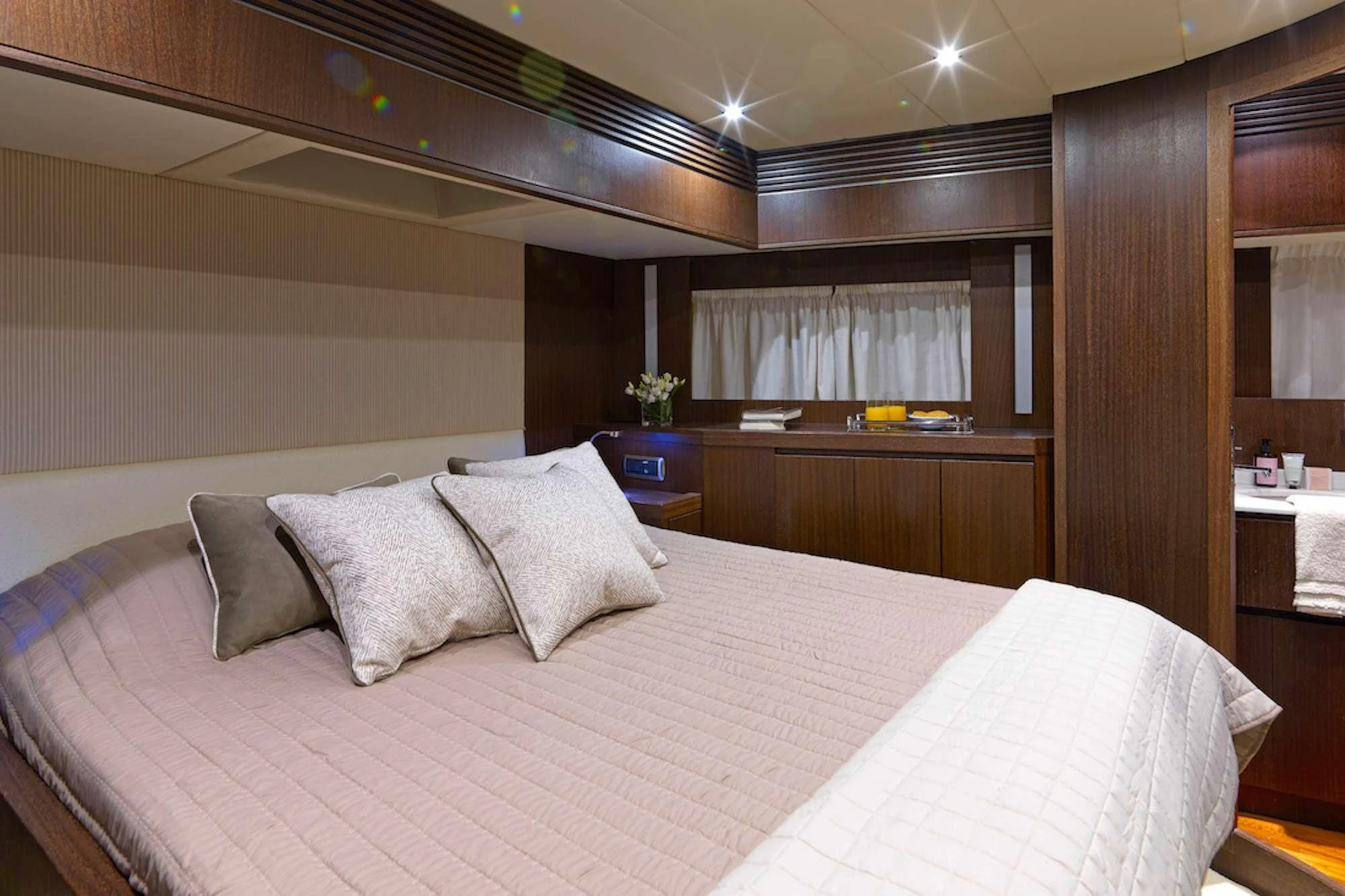 a bed with pillows on it aboard RUBY Yacht for Charter