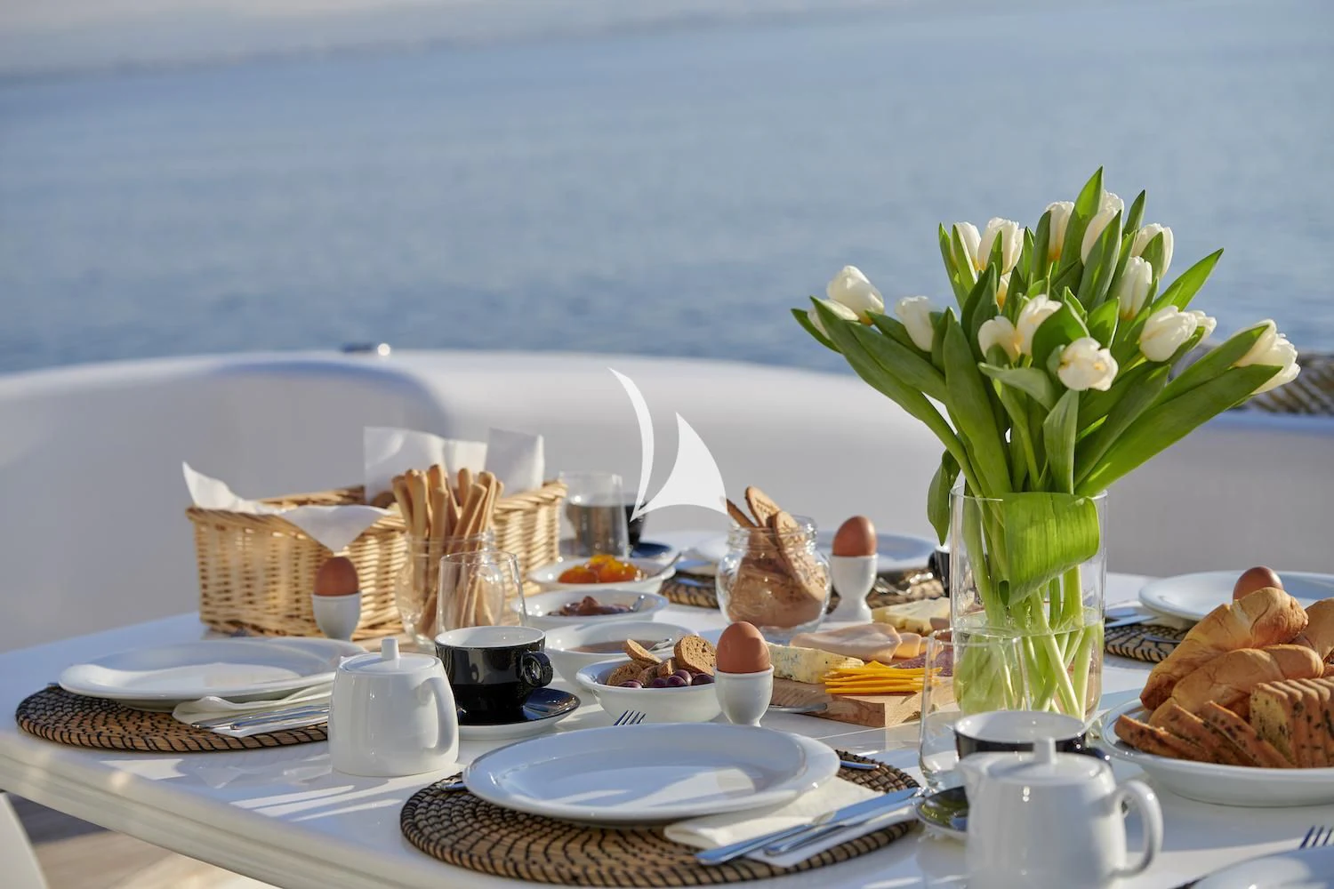 a table with plates and food on it aboard RUBY Yacht for Charter