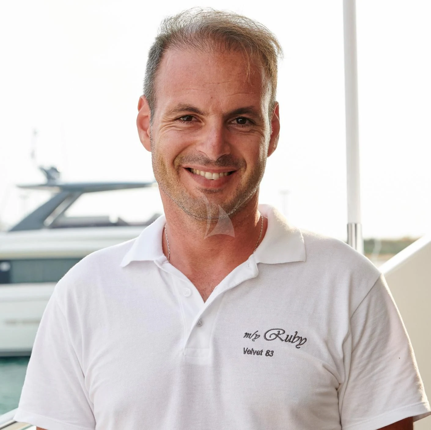 a man smiling for the camera aboard RUBY Yacht for Charter