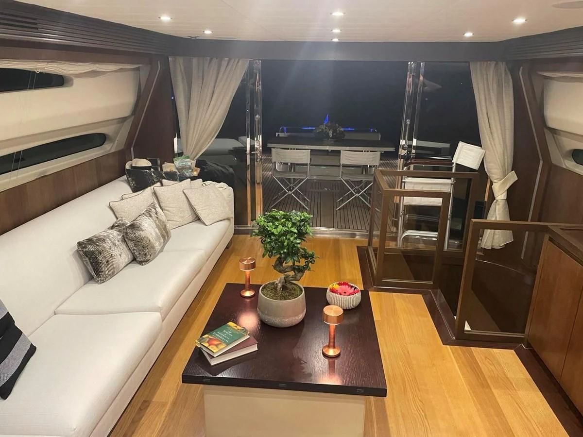 a living room with a large window aboard RUBY Yacht for Charter