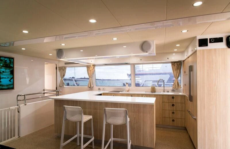 a kitchen with a counter and chairs aboard LA BELLA CHERIE Yacht for Sale