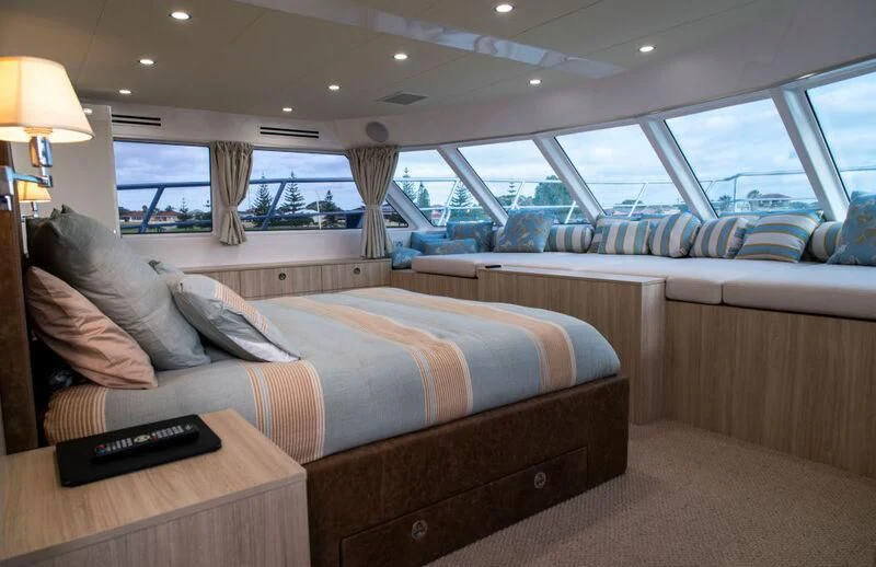 a room with a bed and a couch aboard LA BELLA CHERIE Yacht for Sale