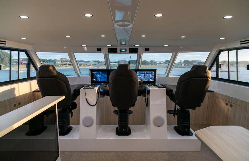 a room with chairs and computers aboard LA BELLA CHERIE Yacht for Sale