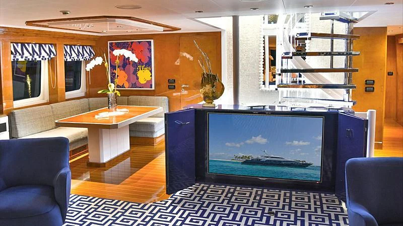 a room with a tv and a couch aboard OCTOPUSSY Yacht for Sale