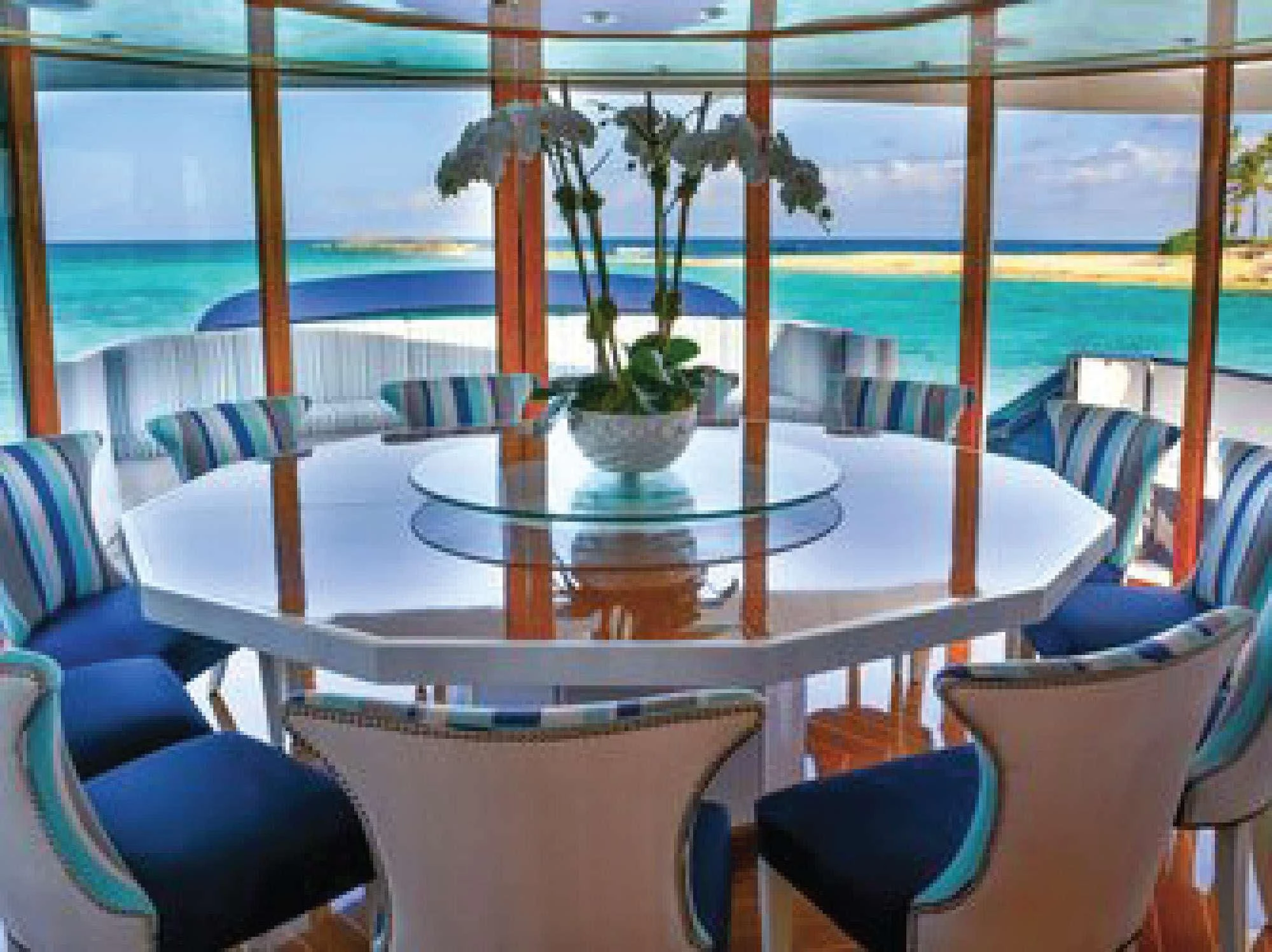 a table with chairs and plants on it aboard OCTOPUSSY Yacht for Sale