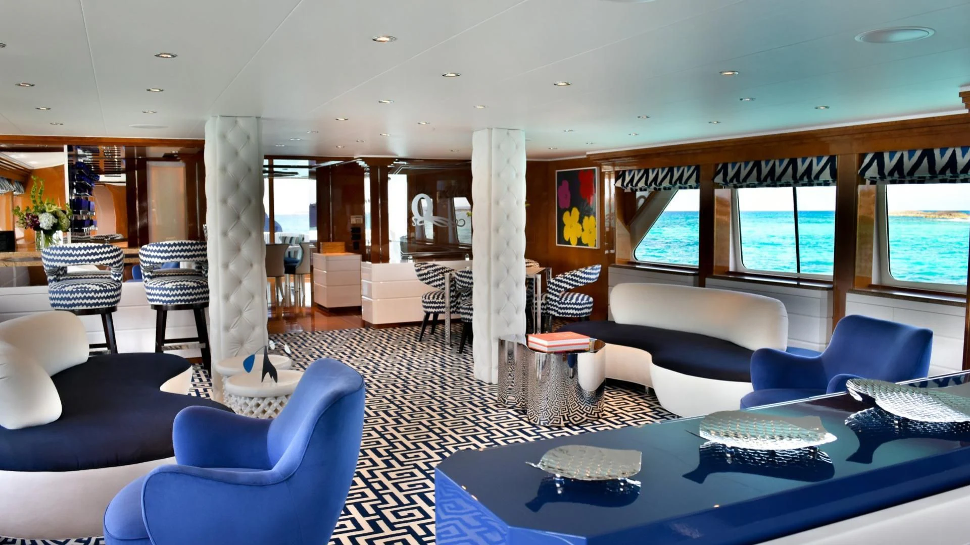 a large room with a pool table and chairs aboard OCTOPUSSY Yacht for Sale