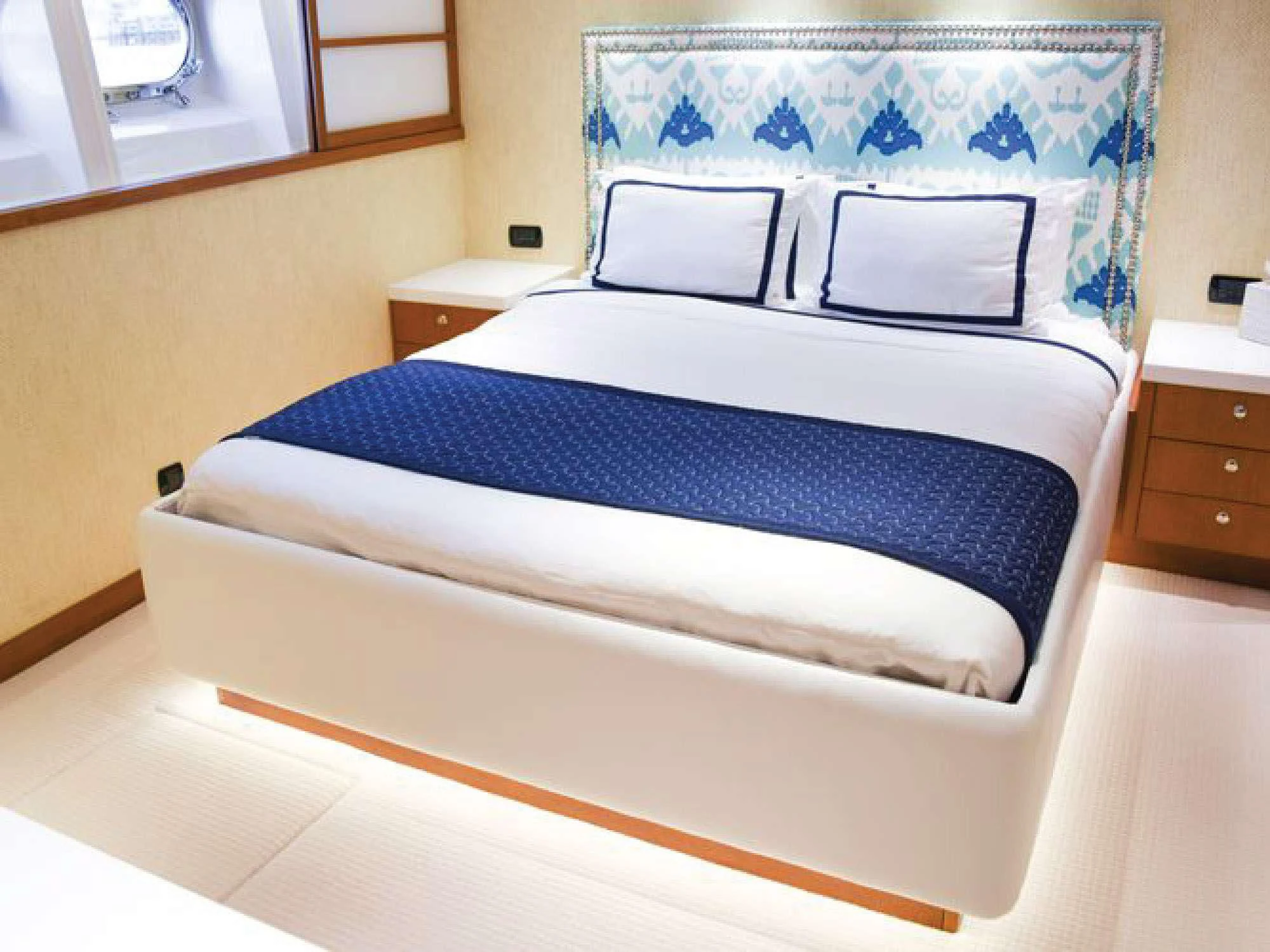 a bed with blue and white sheets aboard OCTOPUSSY Yacht for Sale