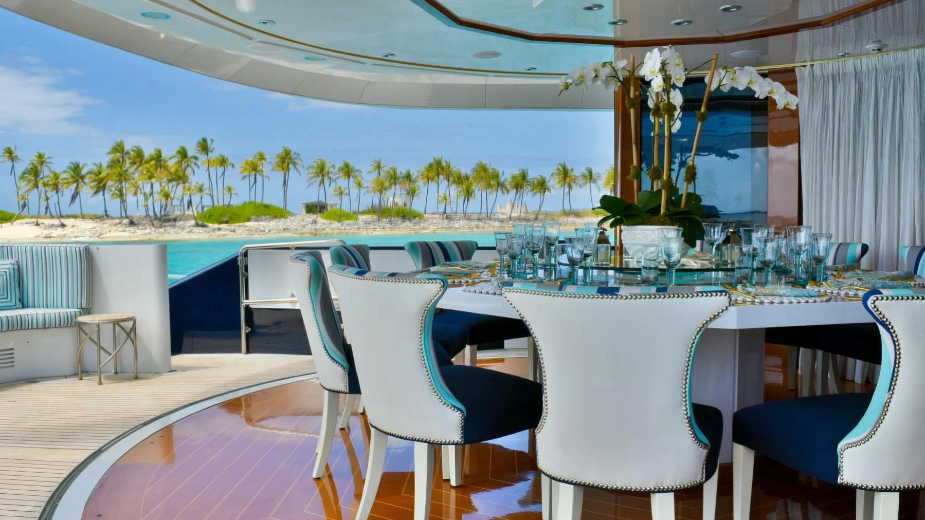 a table and chairs on a patio aboard OCTOPUSSY Yacht for Sale
