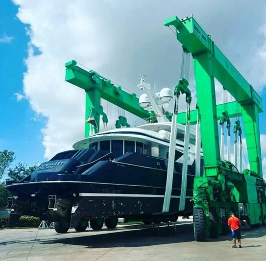 a large green crane on a truck aboard OCTOPUSSY Yacht for Sale