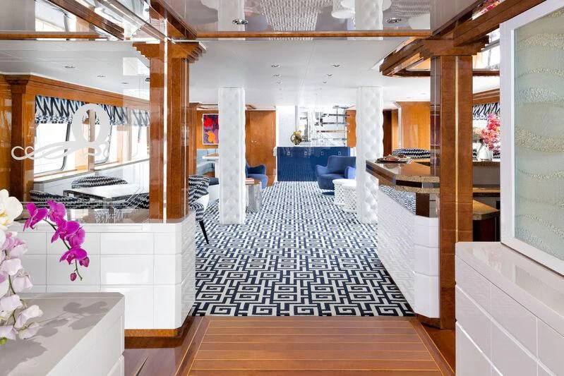 a room with wood floors and a staircase aboard OCTOPUSSY Yacht for Sale