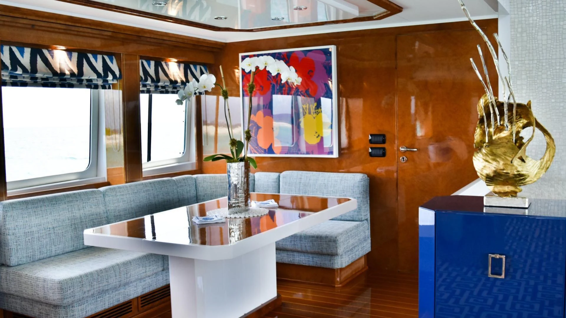 a living room with a table and couches aboard OCTOPUSSY Yacht for Sale
