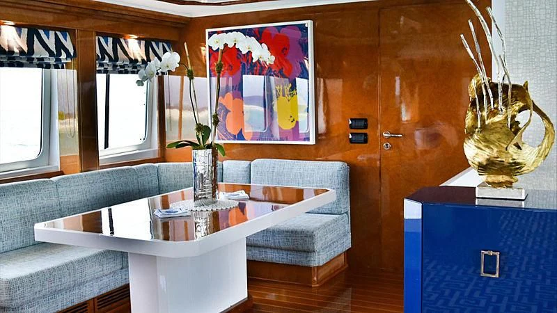 a living room with a couch and a table aboard OCTOPUSSY Yacht for Sale