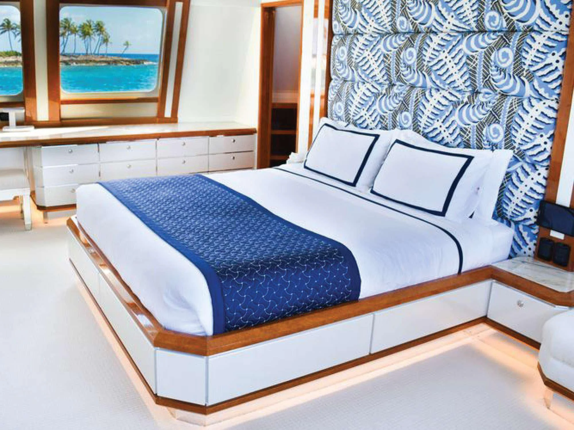 a bed with blue sheets aboard OCTOPUSSY Yacht for Sale