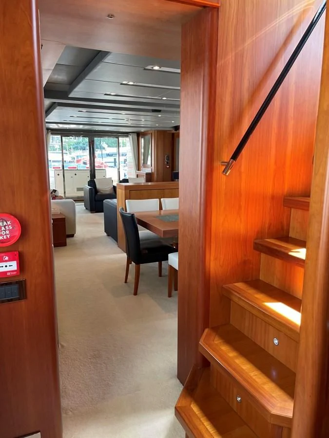 a room with a desk and chairs aboard HARBOUR Yacht for Sale