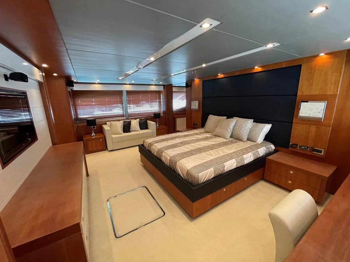 a room with a bed and a couch aboard HARBOUR Yacht for Sale