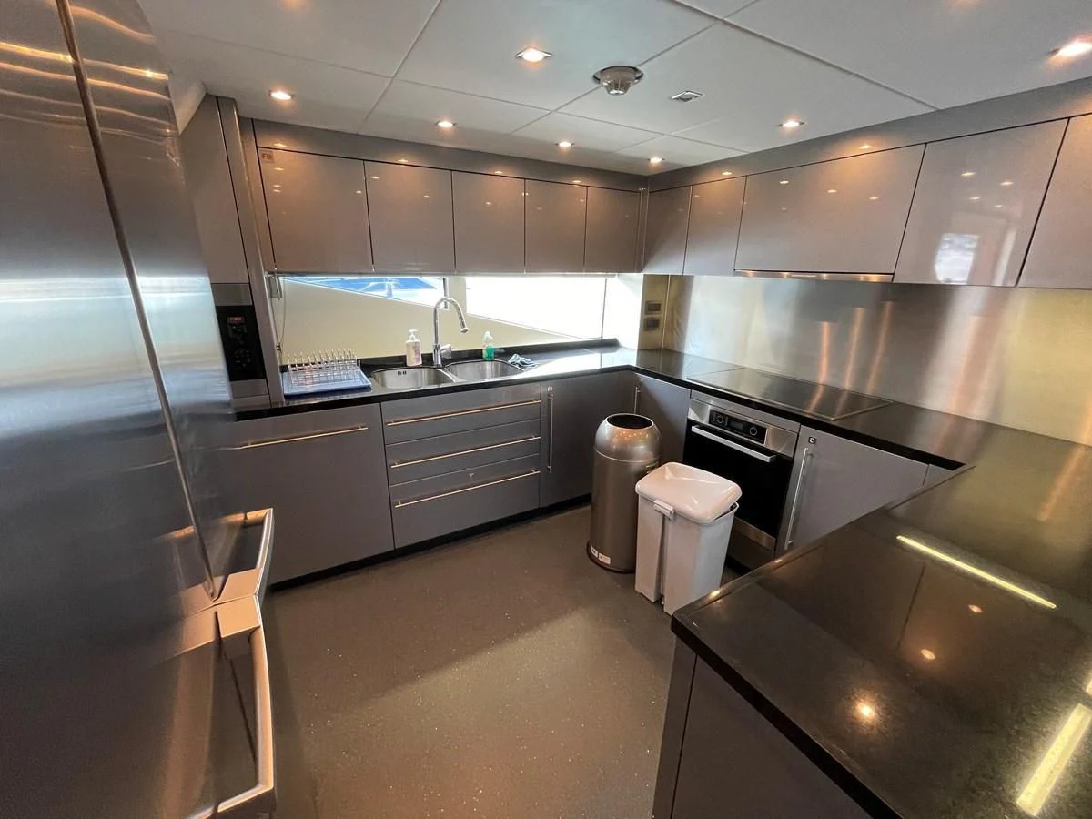 a kitchen with a stainless steel refrigerator aboard HARBOUR Yacht for Sale