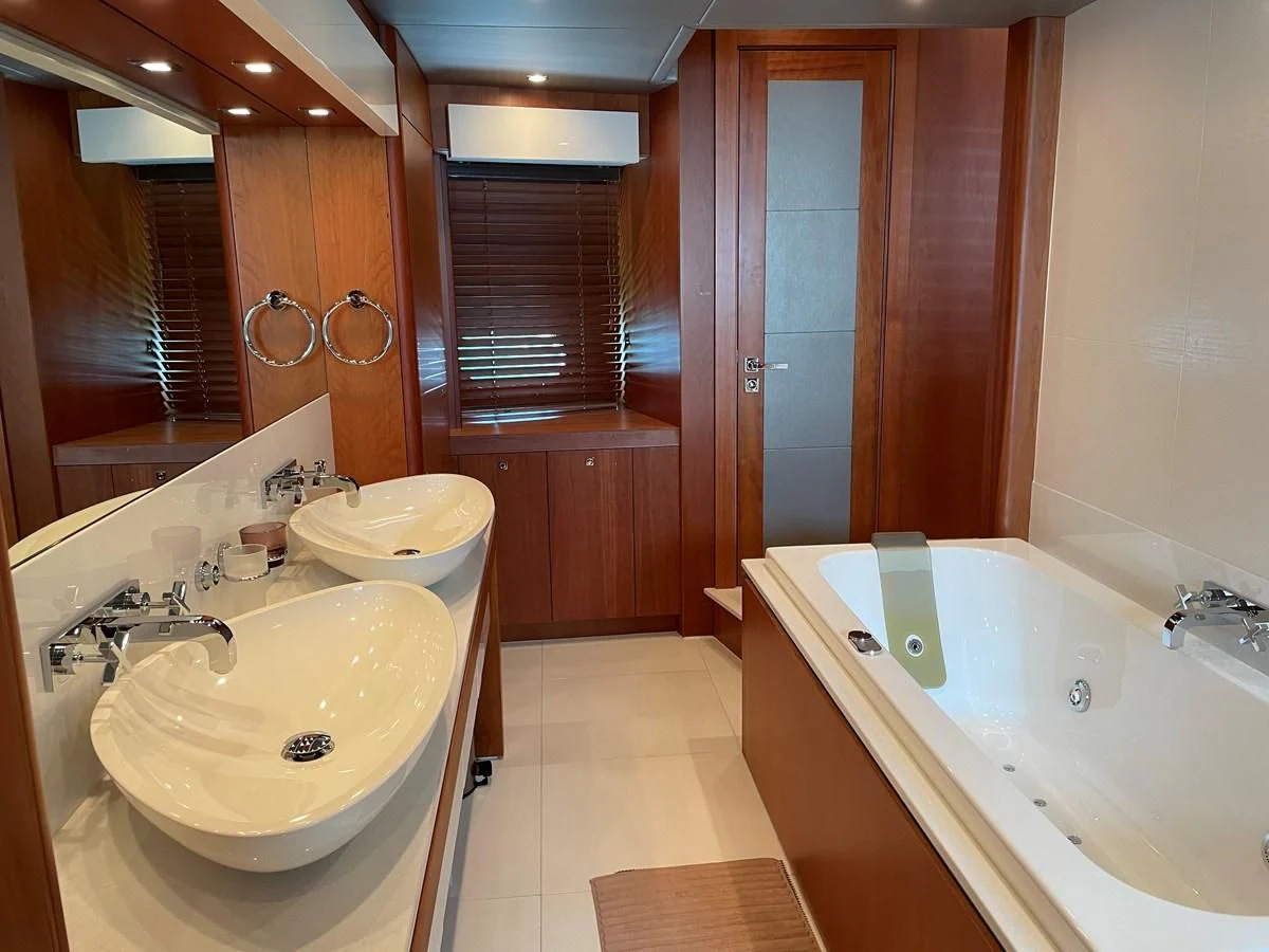 a bathroom with a tub sink and a sink aboard HARBOUR Yacht for Sale