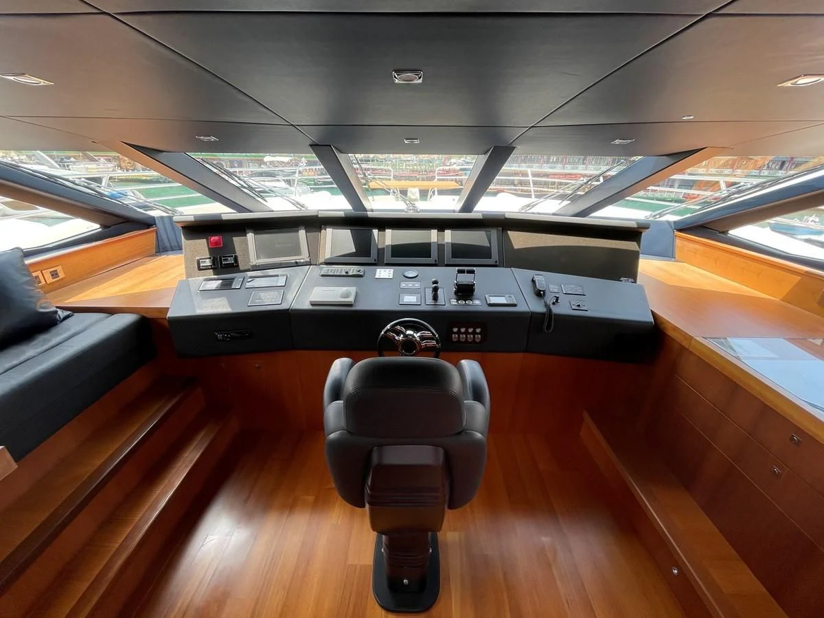 a black and white piano in a room with wooden floors aboard HARBOUR Yacht for Sale