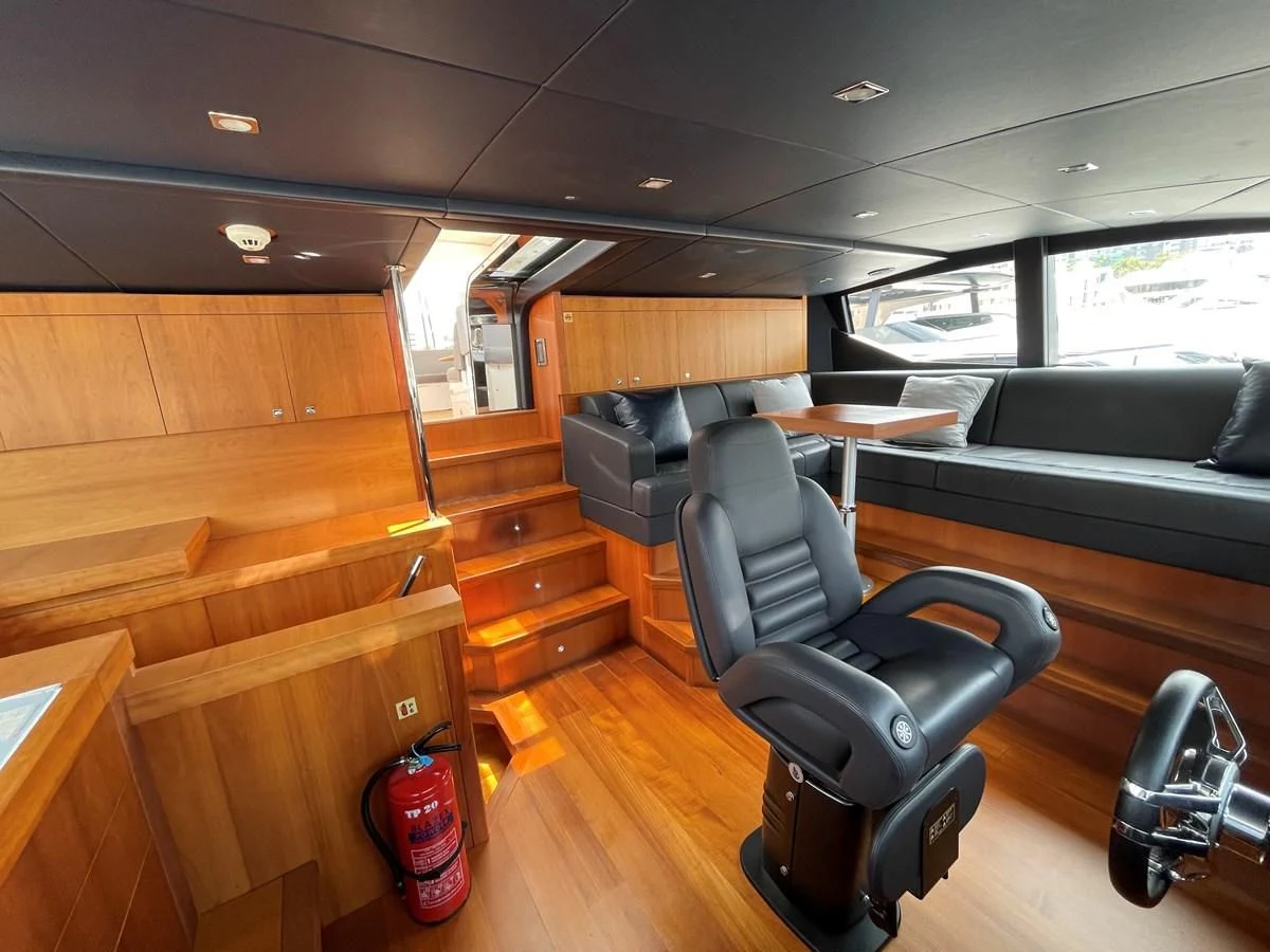 a room with a chair and a table and a couch aboard HARBOUR Yacht for Sale
