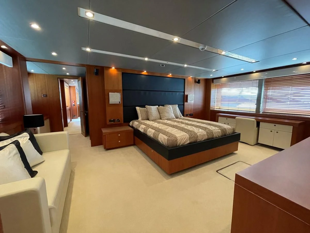 a room with a bed and a desk aboard HARBOUR Yacht for Sale