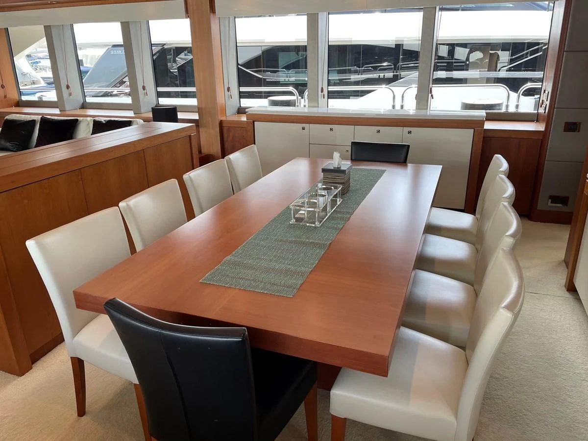 a table with chairs around it aboard HARBOUR Yacht for Sale