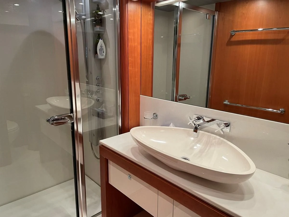 a bathroom with a sink and a shower aboard HARBOUR Yacht for Sale