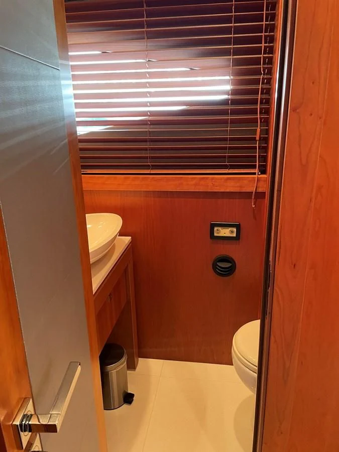 a bathroom with a toilet and a sink aboard HARBOUR Yacht for Sale