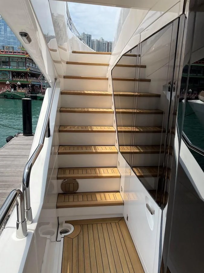 a white boat with wooden handles aboard HARBOUR Yacht for Sale