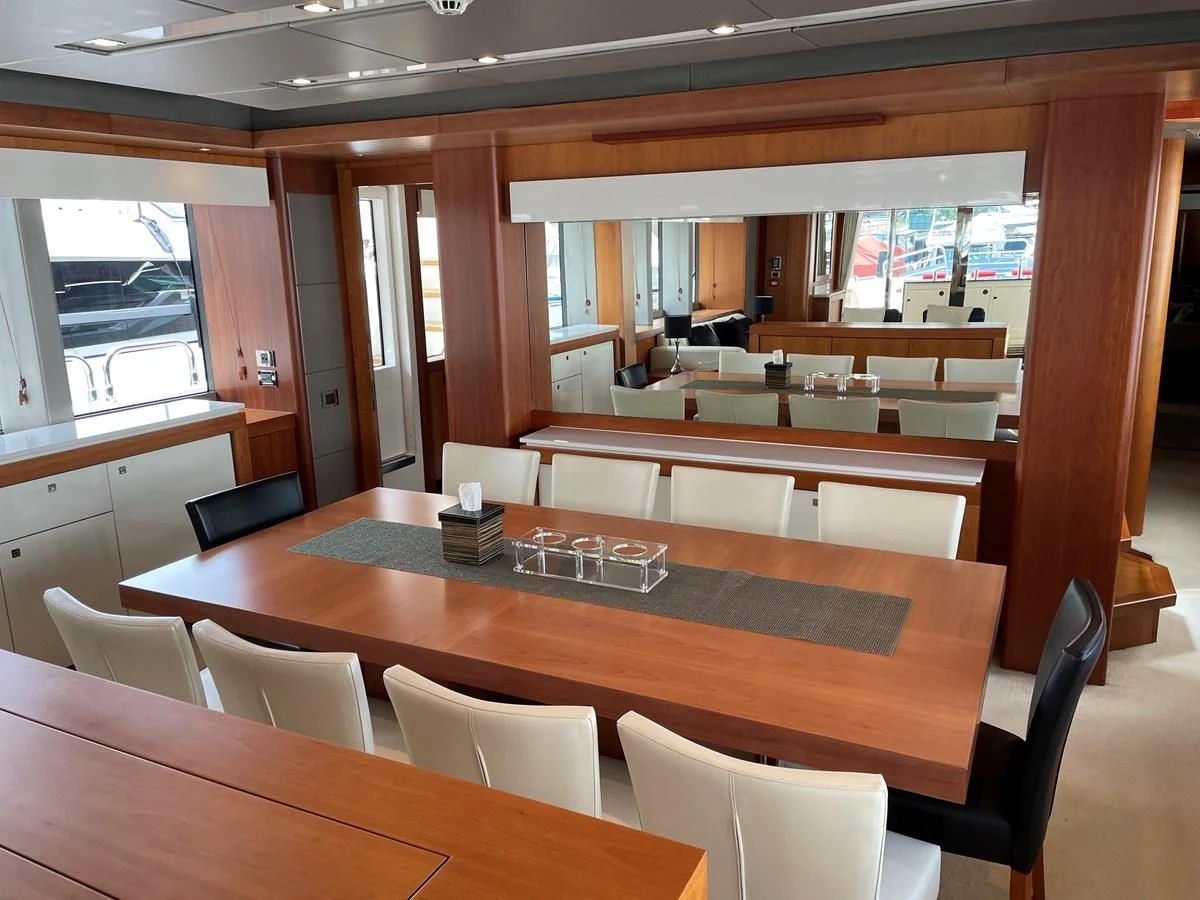 a room with a table and chairs aboard HARBOUR Yacht for Sale