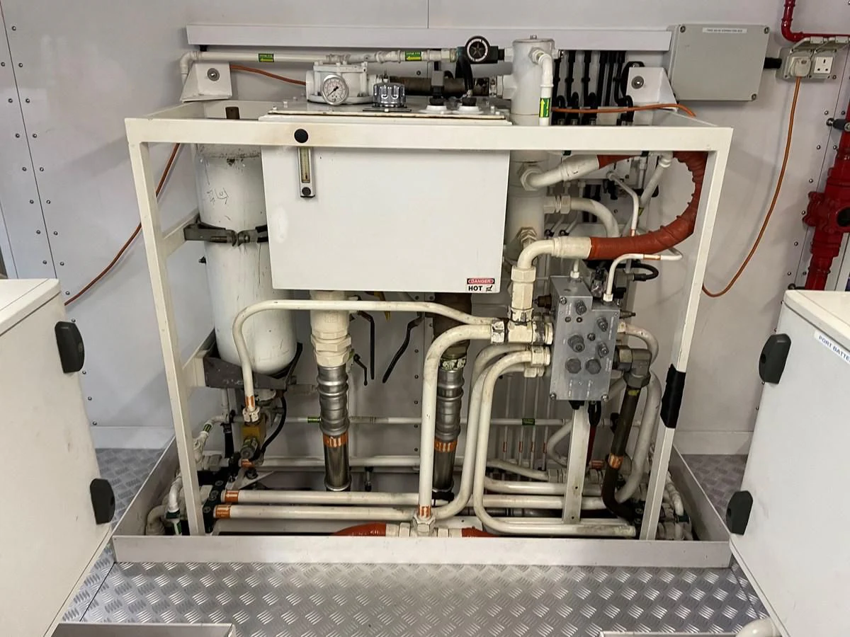 a white machine with a red cable aboard HARBOUR Yacht for Sale