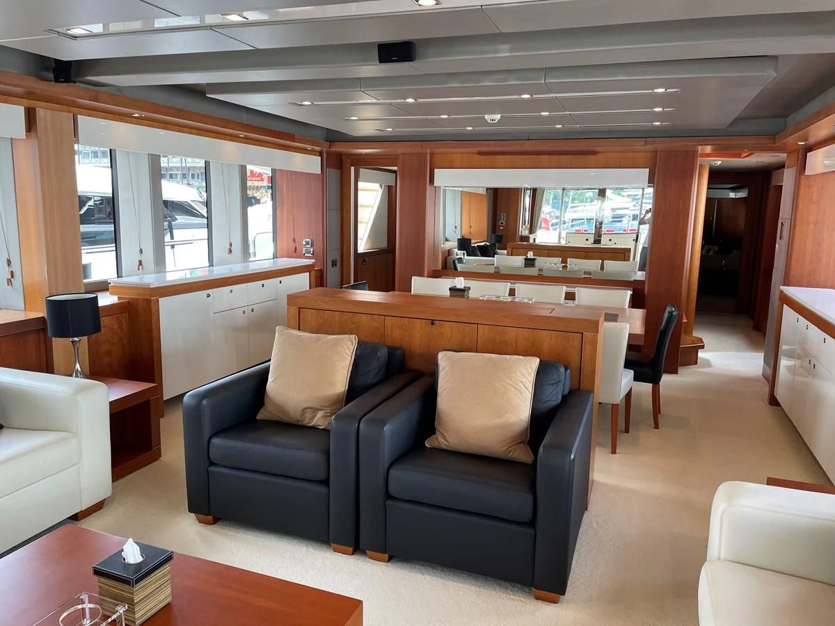 a living room with a couch and a piano aboard HARBOUR Yacht for Sale