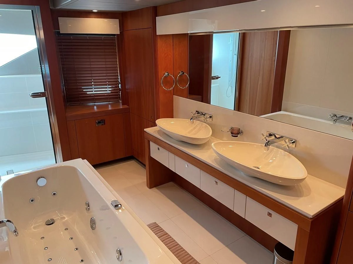 a bathroom with a tub sink and a sink aboard HARBOUR Yacht for Sale