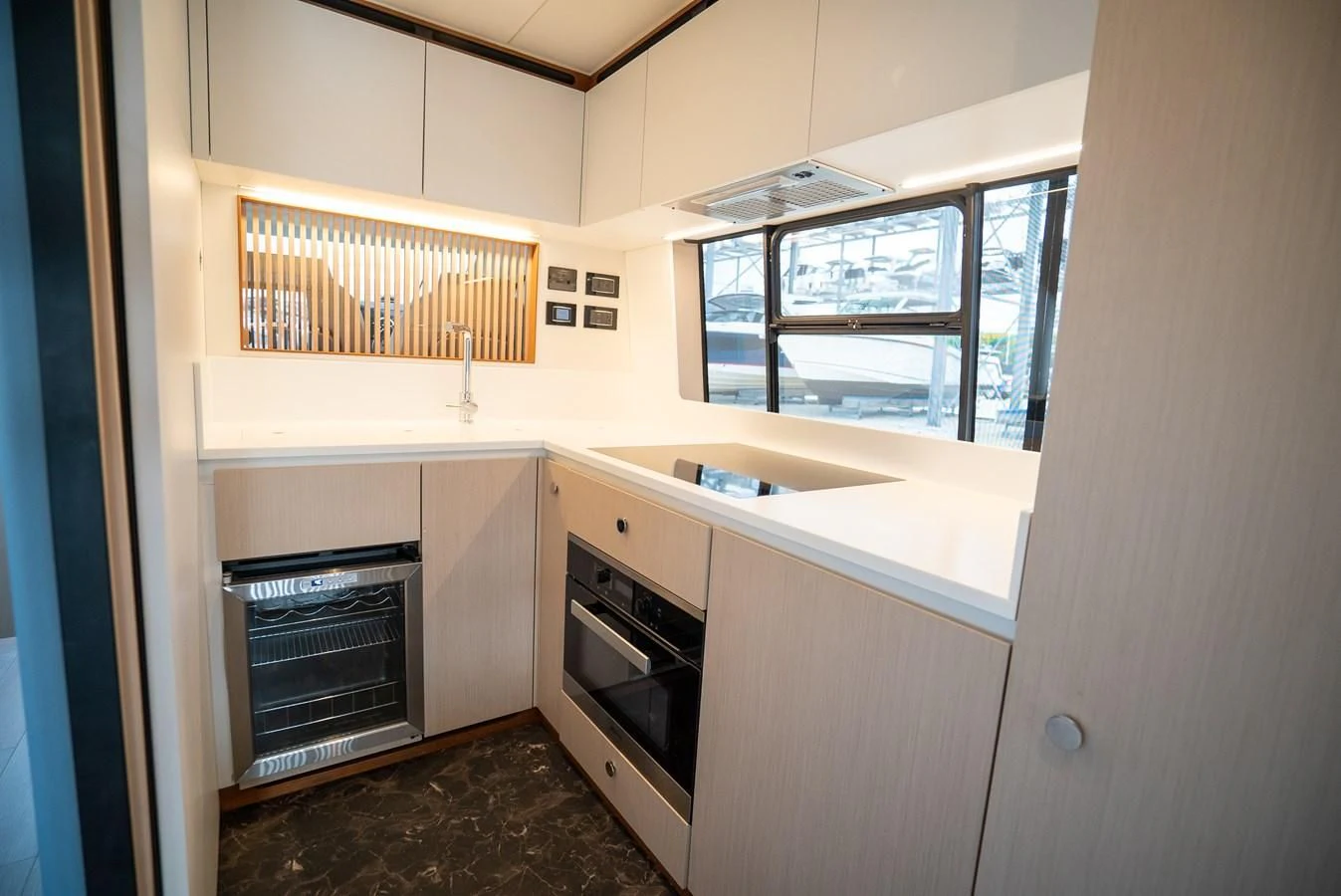 a kitchen with a stove and a sink aboard 2023 AZIMUT FLY 78/56 Yacht for Sale