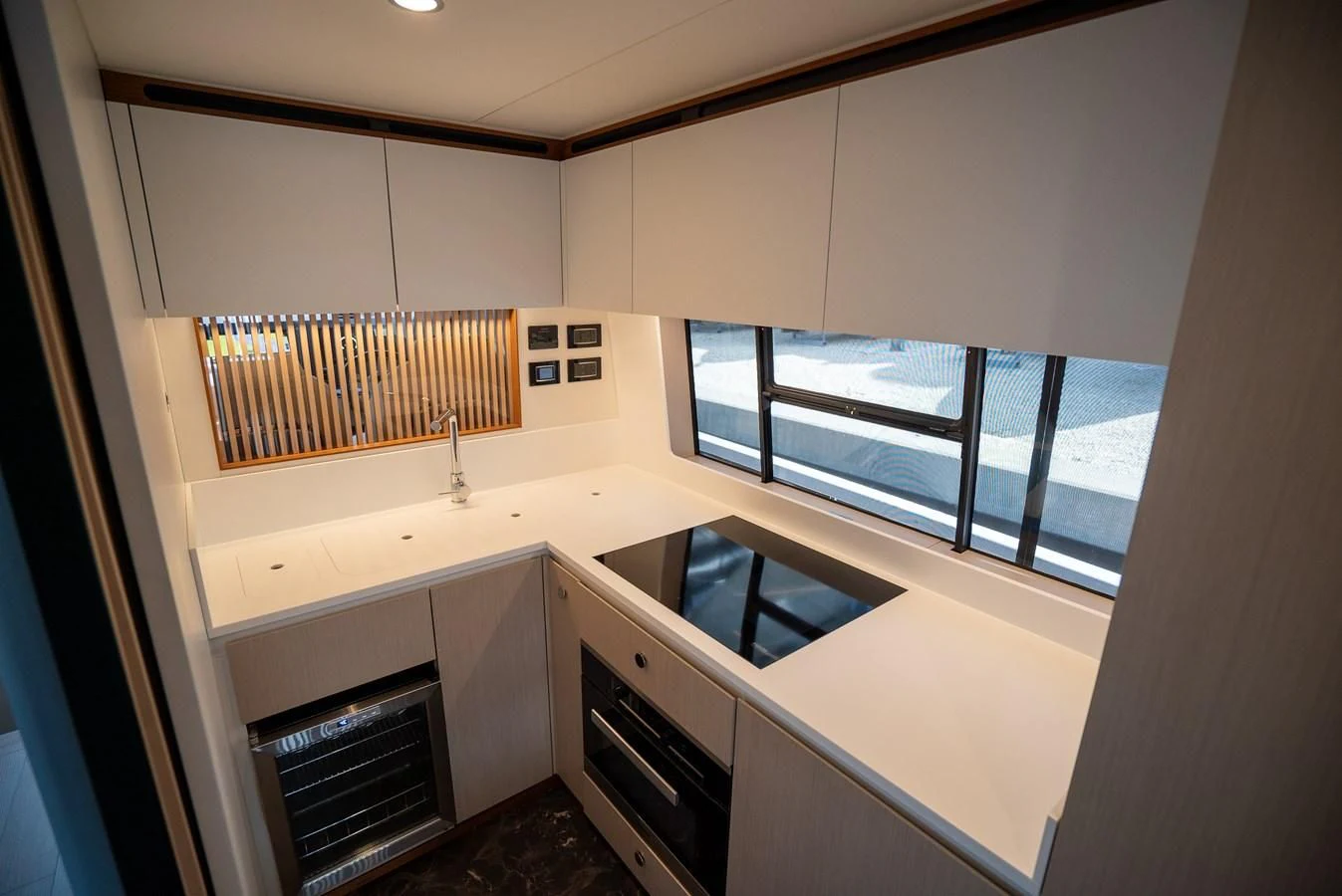 a kitchen with a large window aboard 2023 AZIMUT FLY 78/56 Yacht for Sale